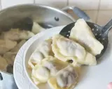 Gotowanie pierogów: gdy wypłyną na powierzchnię, gotuj jeszcze 2-3 minuty. Na talerzu czeka porcja świeżo ugotowanych, parujących pierogów.