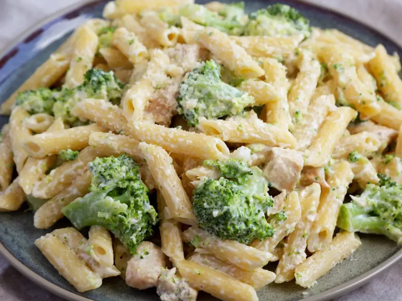 Penne z kurczakiem i brokułami w kremowym sosie, posypane parmezanem. Pyszne danie, które zadowoli każdego miłośnika makaronu z brokułami.
